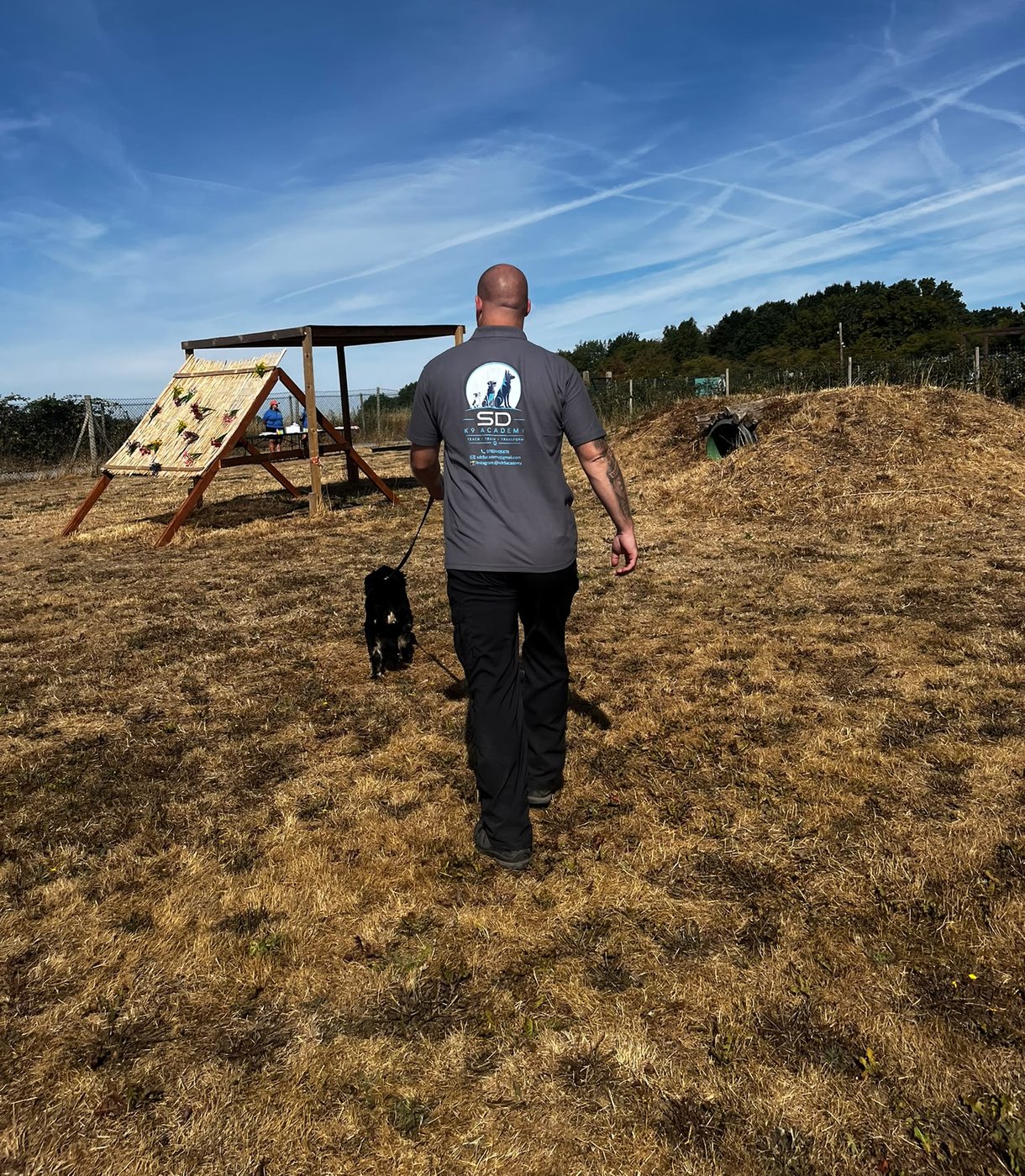Steve from SDK9 Academy walking a dog on lead during a training session in Surrey